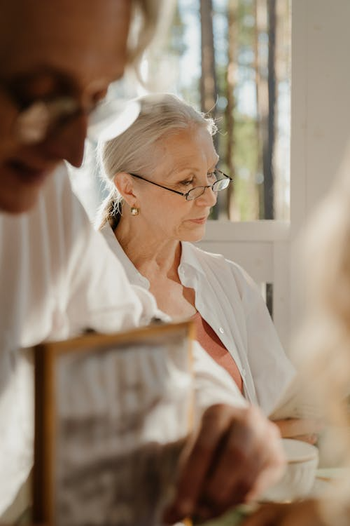an elderly woman in a white blouse