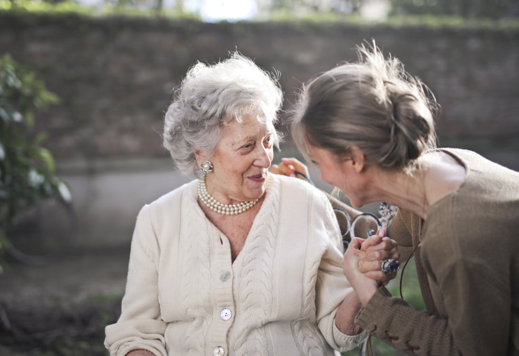an elderly woman sitting outdoors