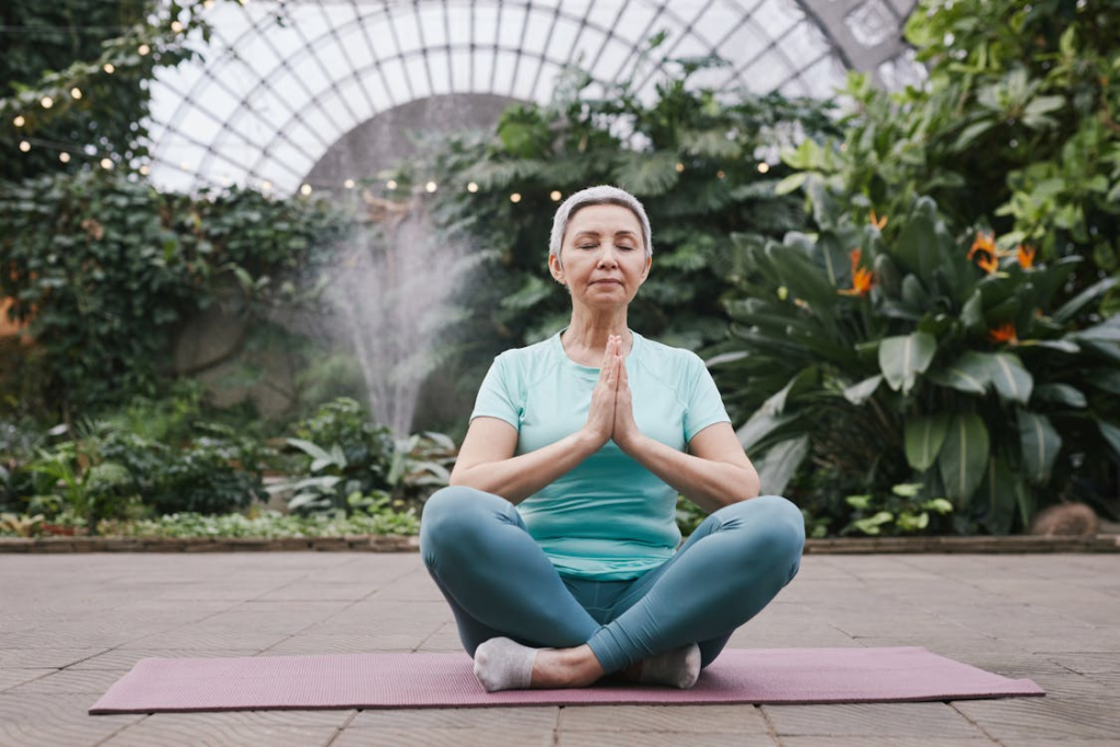 a woman sitting on a yoga mat