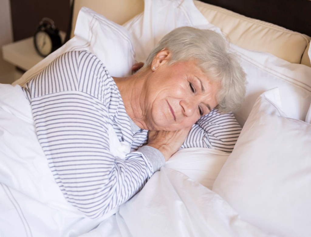 Elderly-soman-resting-in-bed-after-daily-routine.webp