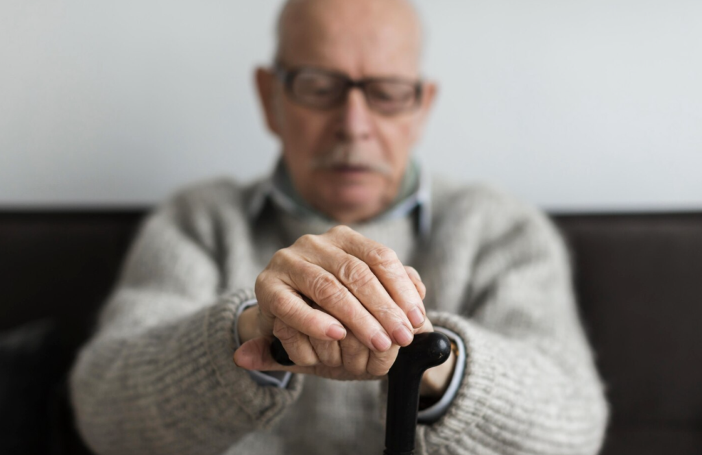 Older man experiencing hand tremors affecting daily activities