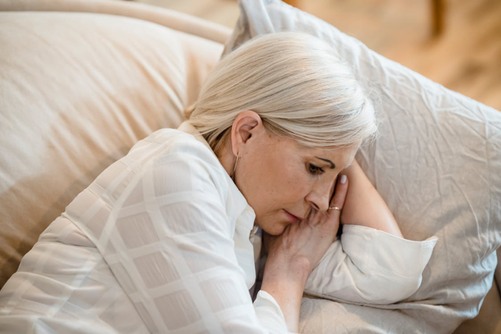 a woman with gray hair taking a nap