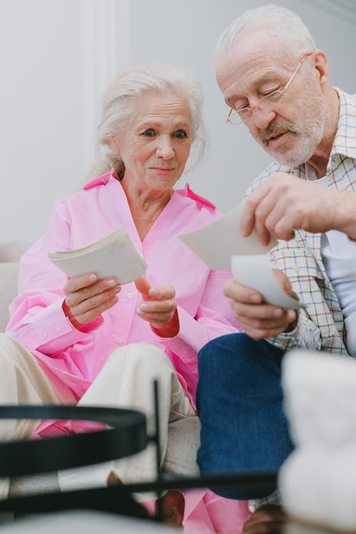 an elderly couple sitting on the couch