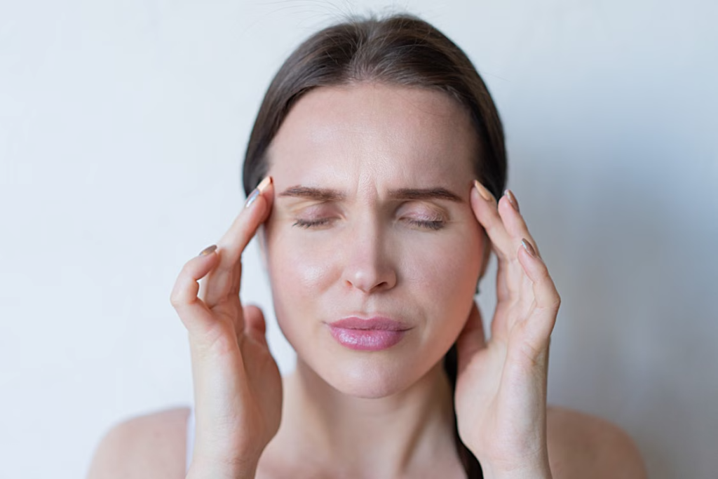 A-person-massaging-their-temples.webp