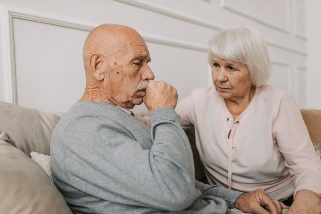 Older-couple-discussing-early-movement-disorder-symptoms-and-neurological-concerns-at-home.webp