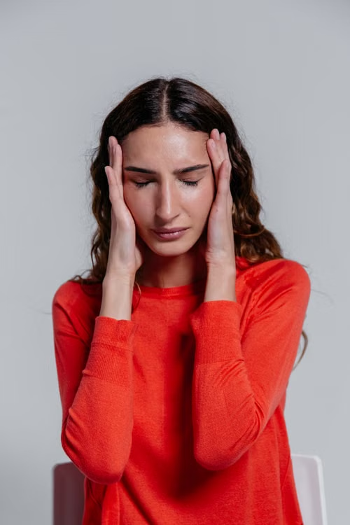 a-woman-with-brown-hair-in-a-red-shirt.webp
